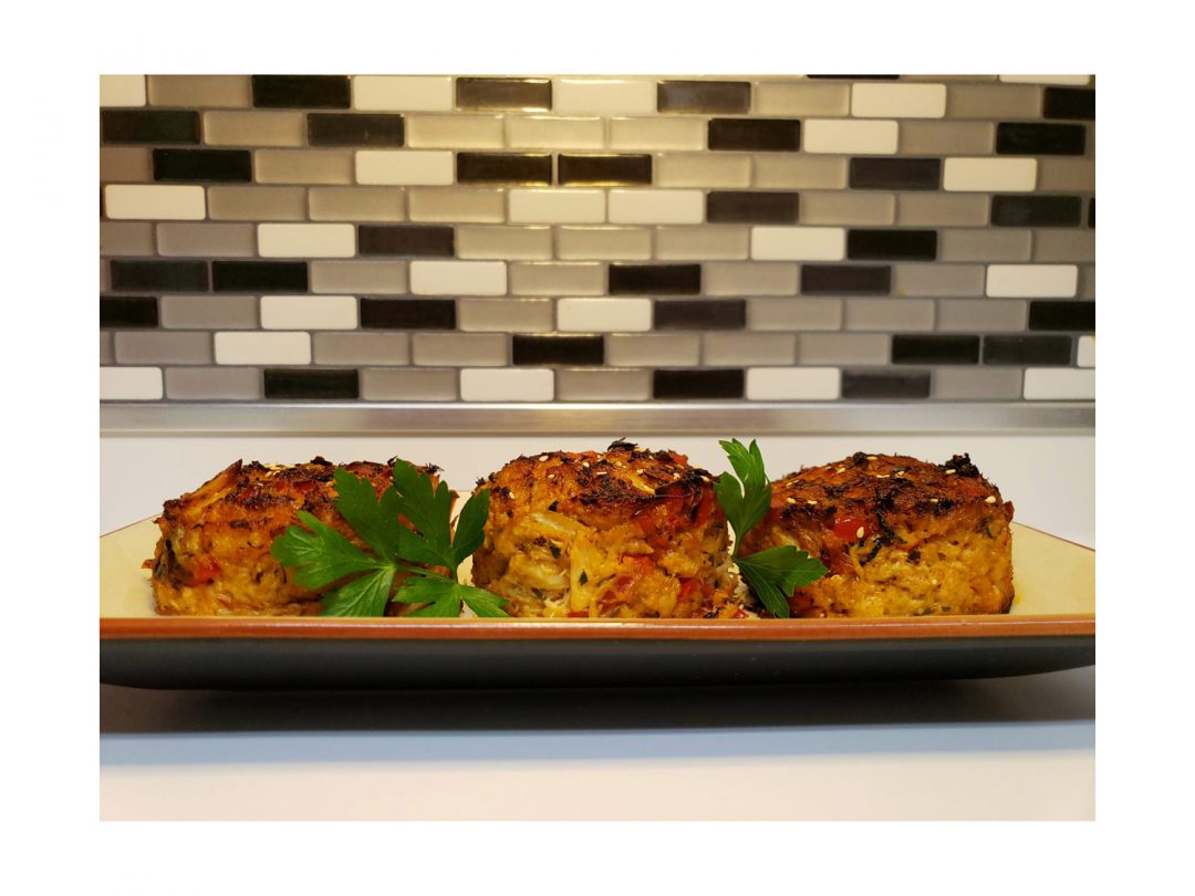Mile-High Crab Cakes on a tray on a countertop.