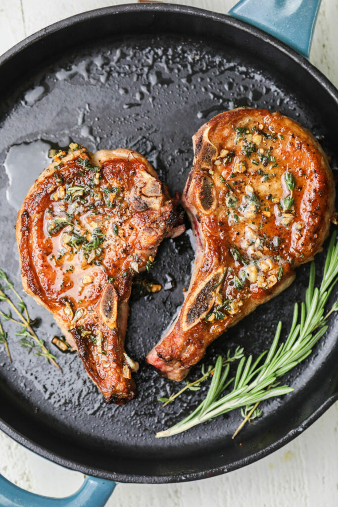 Pork chops being pan seared in a Sharp Induction Cooktop (SCH3043GB)