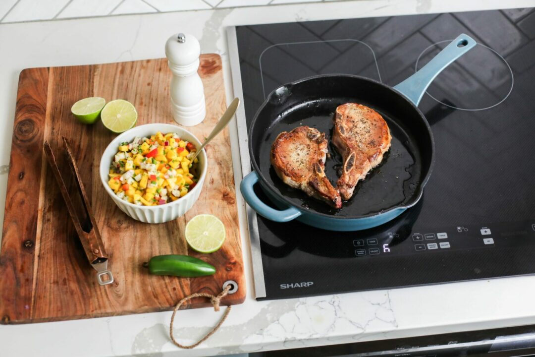 Pan seared pork chops on a Sharp Induction Cooktop (SCH3043GB) with a side of mango salsa
