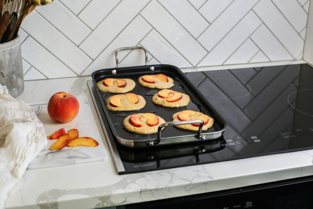 Peach pancakes cooking on a sharp induction cooktop