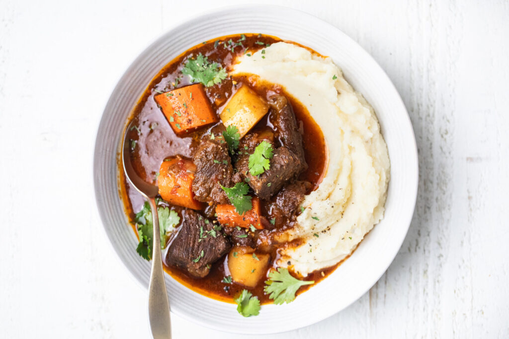 Moroccan Beef stew in a bowl with mashed potatoes