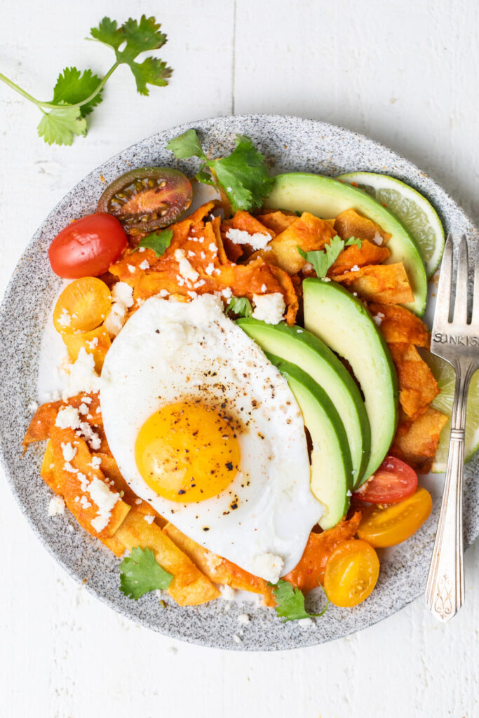 Chilaquiles Rojos plated with sunny side eggs