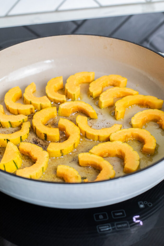 Delicata squash being seared in a pan on a Sharp Induction Cooktop