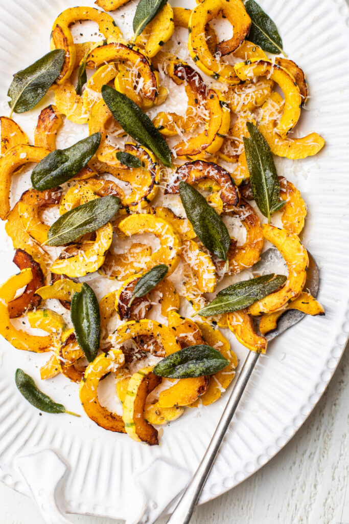 Sauteed Delicata Squash cooked on a plate with cripsy fried sage