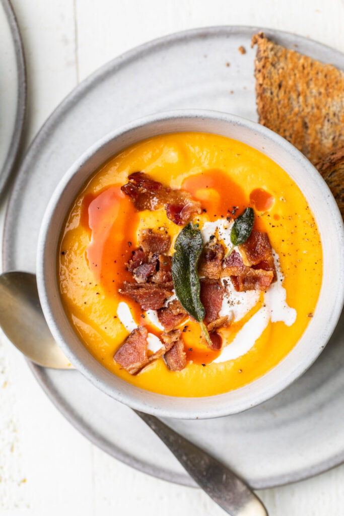 Butternut squash soup in a bowl with toppings