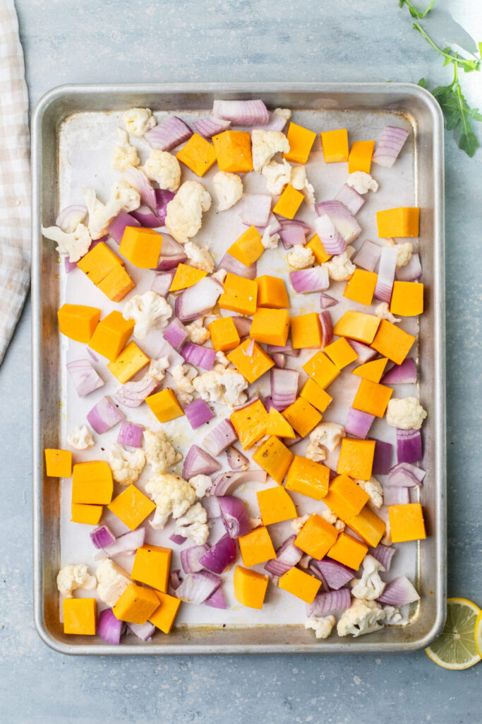 Squash, red onion, and cauliflower in a pan