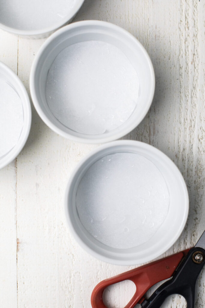 Parchment paper lining the bottom of ramekin dishes