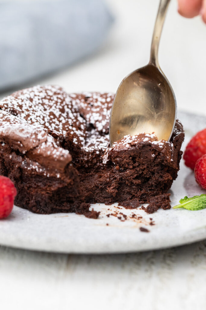 Chocolate souffle cake getting eaten with a spoon