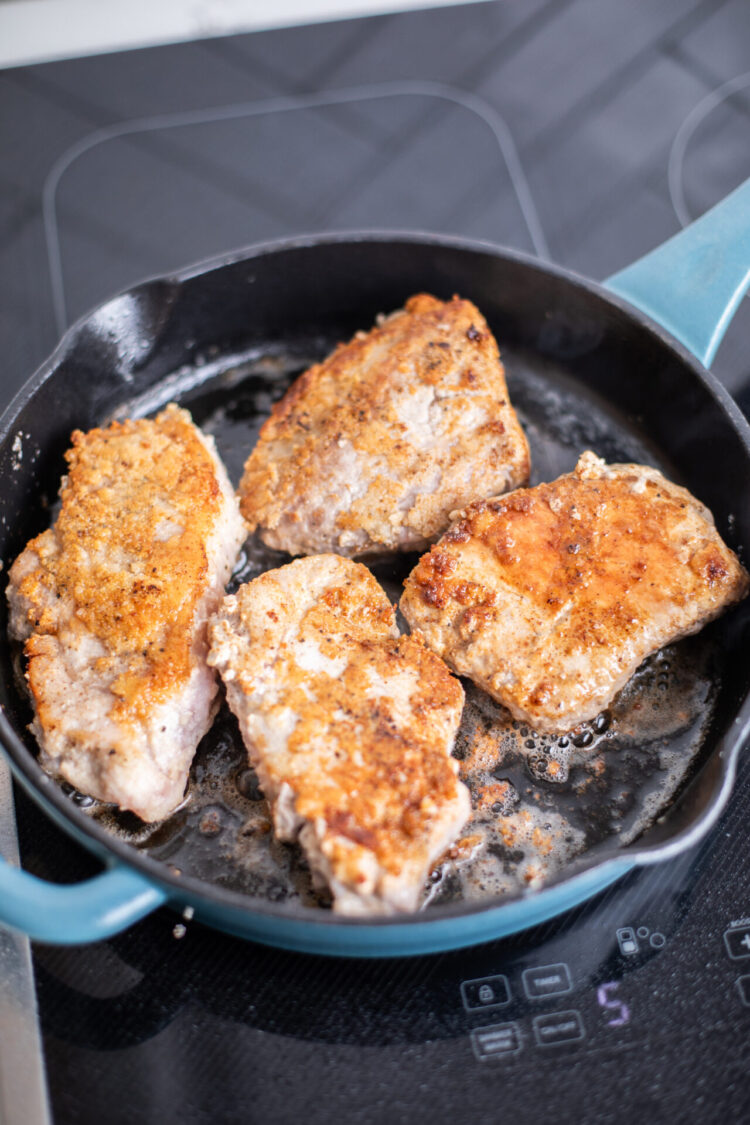 cripsy pork chops searing on a sharp induction cooktop