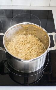  tossing quinoa in a pot