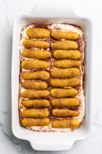 adding a second layer of espresso-soaked lady fingers. 