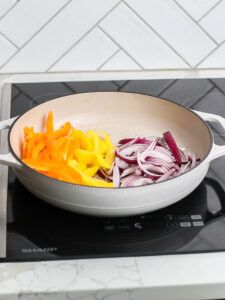 Bell peppers and onions in a saucepan