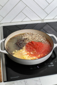Saucepan with quinoa, black beans, corn, and crushed tomatoes 