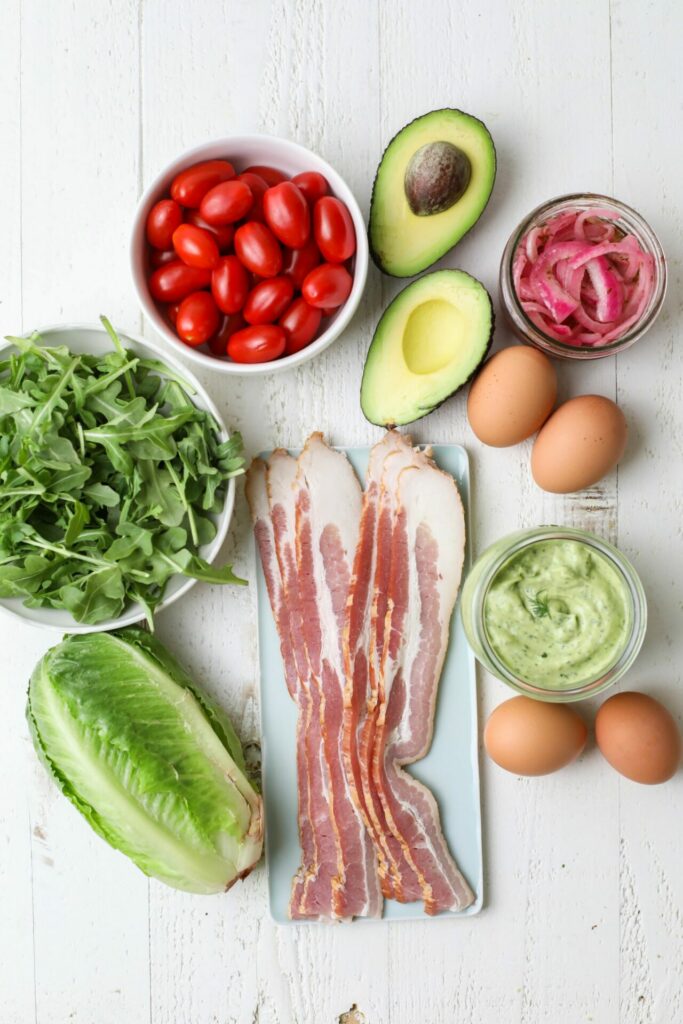 Tomatoes, lettuce, bacon and other ingredients for a Cobb Salad