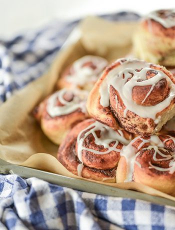 Homemade Cinnamon Rolls on a blue checkered tablecloth.