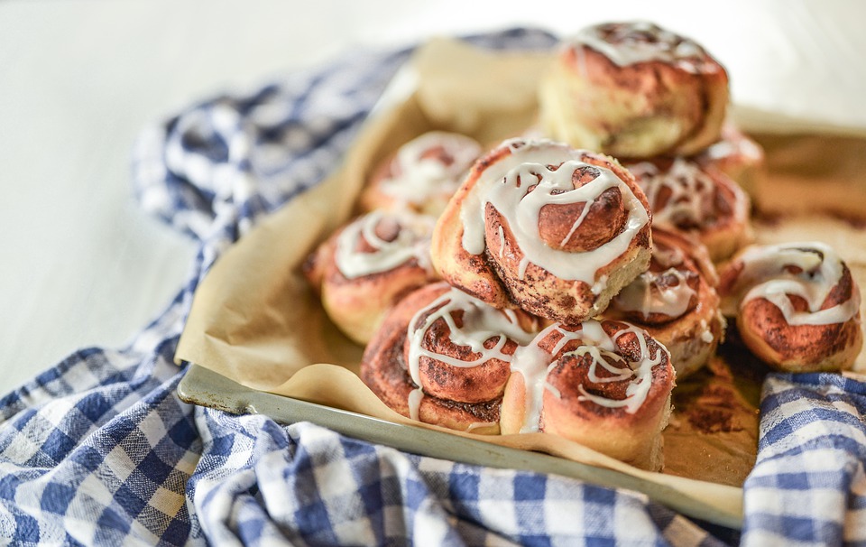 Homemade Cinnamon Rolls on a blue checkered tablecloth.