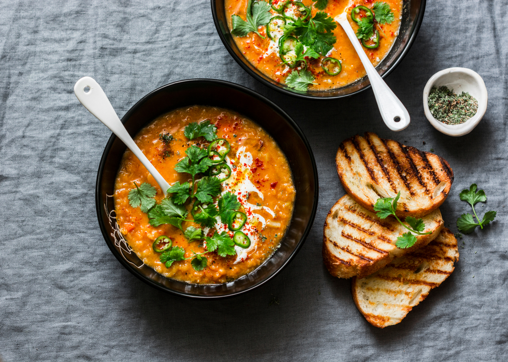 two bowls of soup with toasted bread