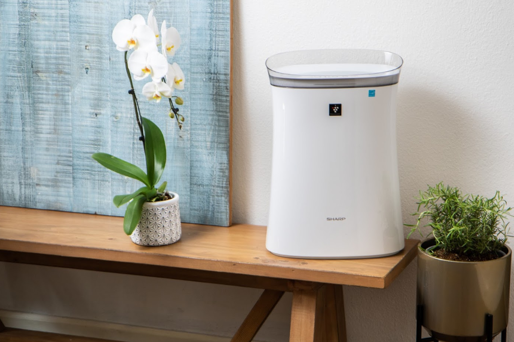 air purifier on a bench next to flowers