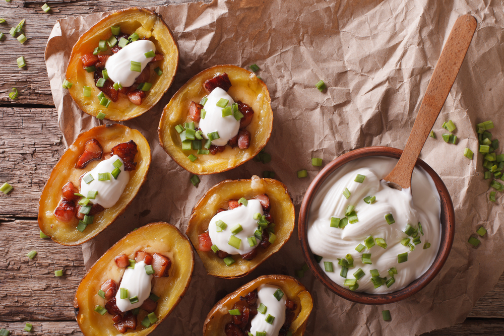 baked potato skins with bacon and sour cream on top