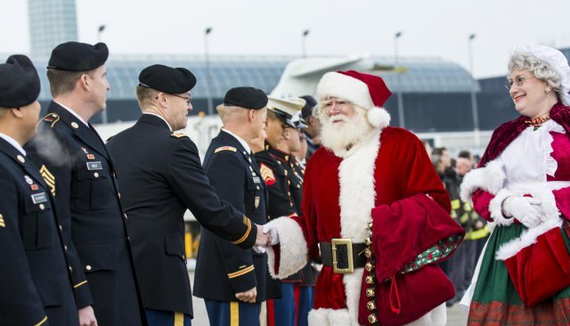 Santa shaking hands with military personnel