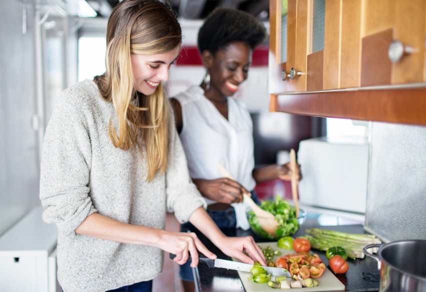 two woman making salad