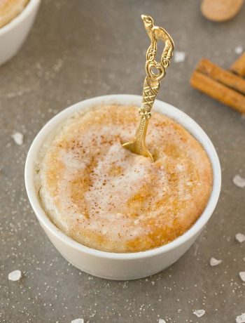 Cinnamon Roll Mug Cake with a golden spoon