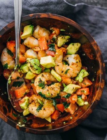 Shrimp Avocado Salad With Tomatoes and Feta in a wooden bowl