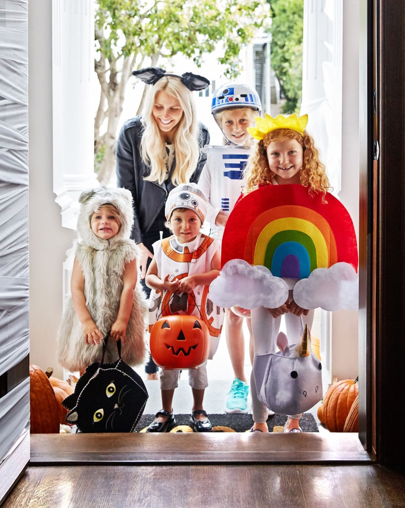 Family trick or treating at the doorstep.