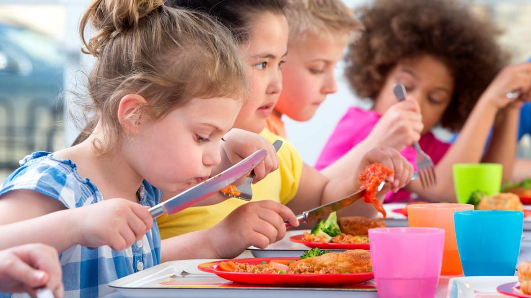 Children eating school lunches.