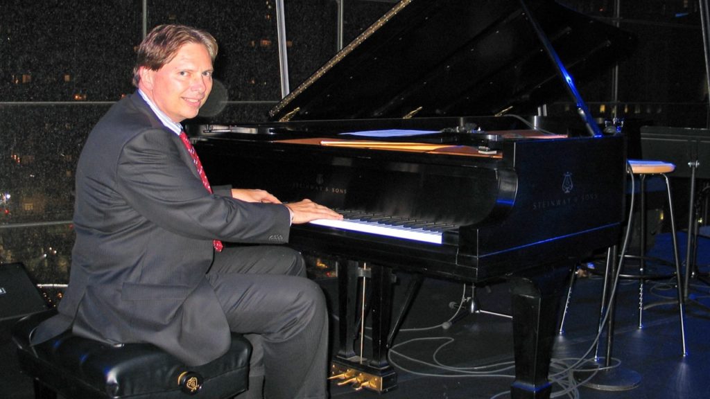 Peter Weedfald playing a grand piano