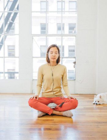 Woman practicing mindfulness in an urban apartment.