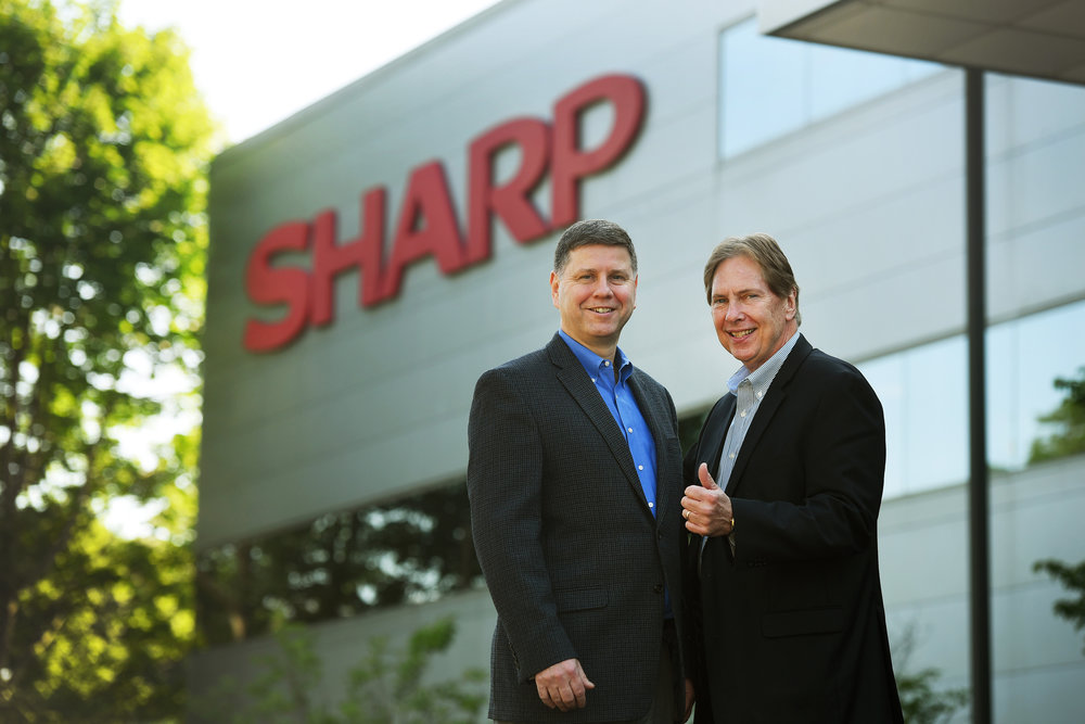 Jim Sanduski and Peter Weedfald outside of Sharp Electronics headquarters.