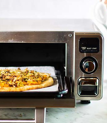Pizza being prepared in a Sharp Superheated Steam Countertop Oven