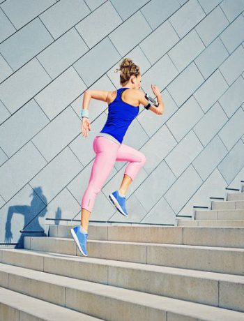 Woman jogging along steps.