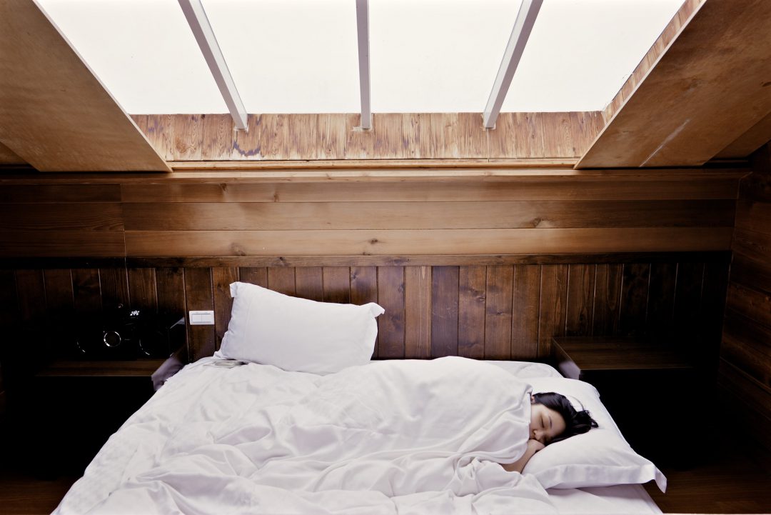 A woman sleeping in a bed.