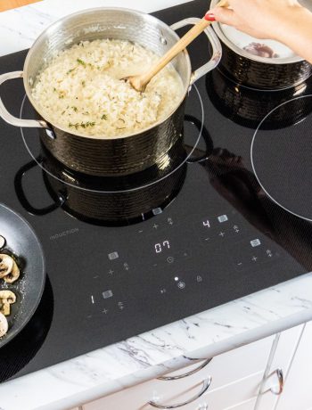 Rice cooking in a pot on an induction cooktop.