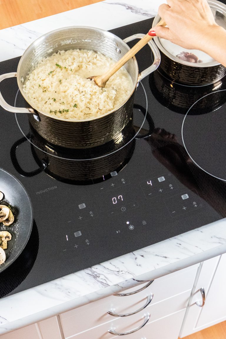 Rice cooking in a pot on an induction cooktop.