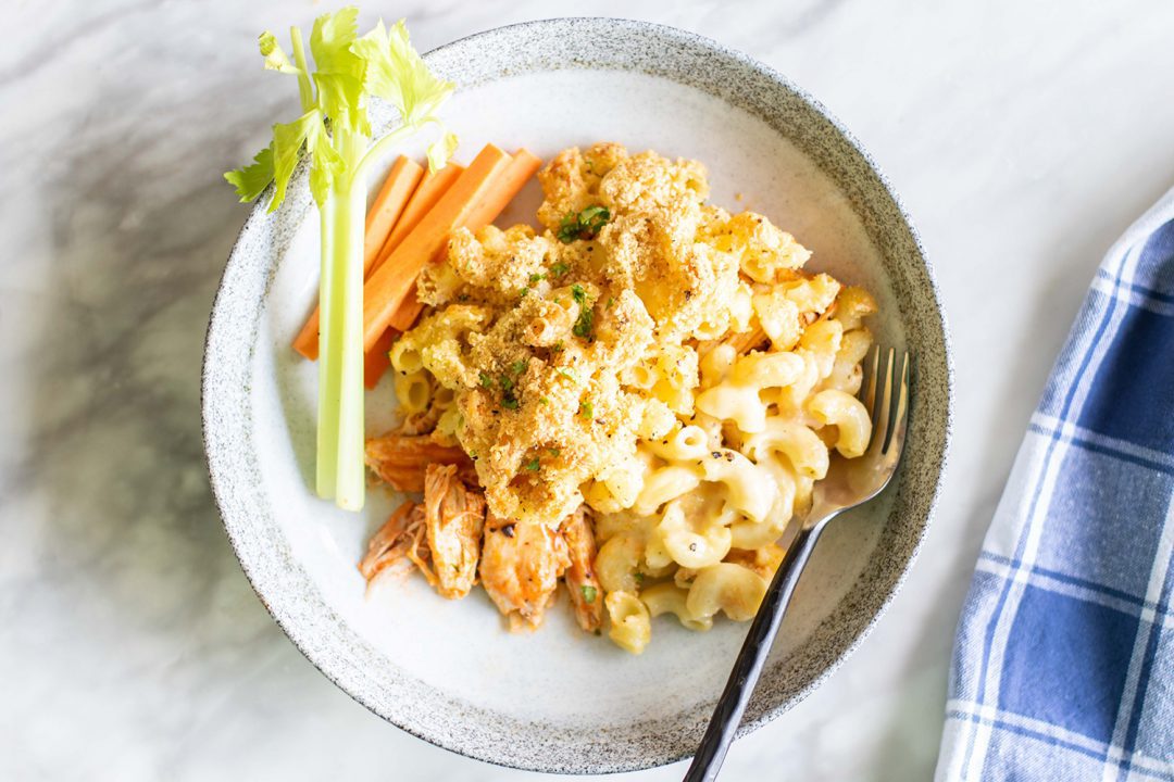Buffalo Chicken Mac and Cheese on a plate with carrots.
