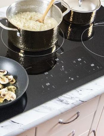 Rice and mushrooms cooking on an induction cooktop.