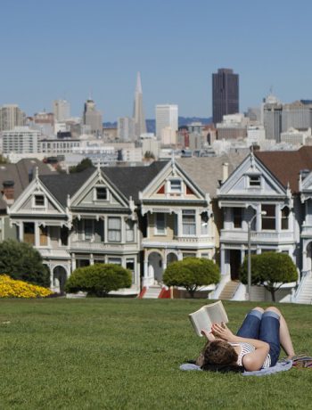 A woman reading in a park in San Francisco.