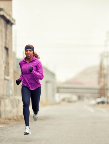 Woman jogging in an urban setting.