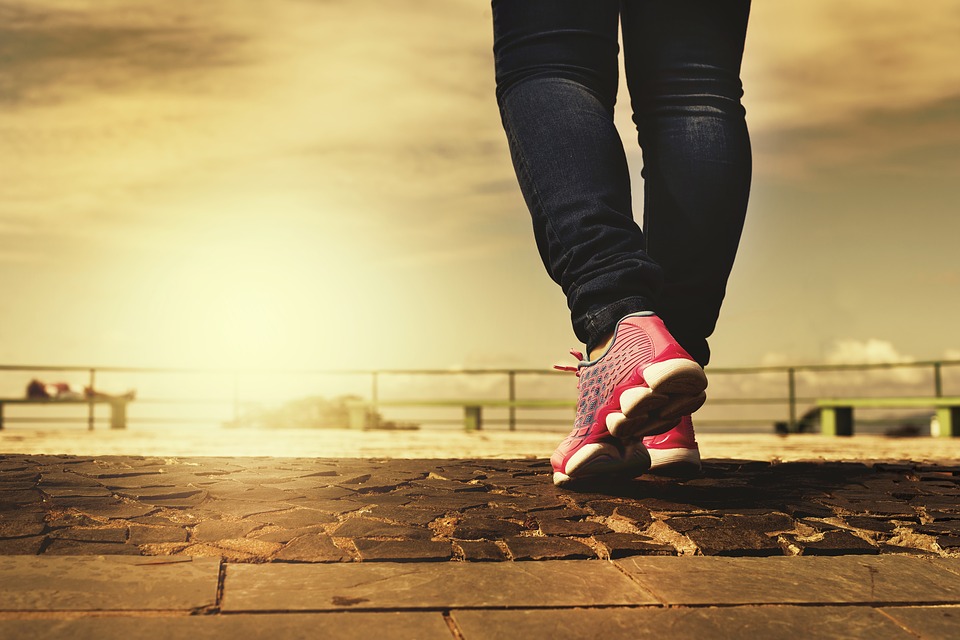 A woman on a pier jogging.