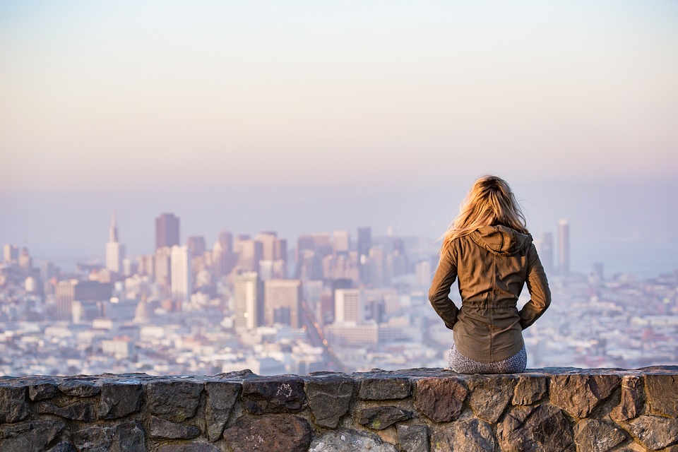 Woman overlooking city landscape.