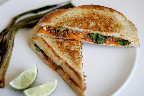 Grilled cheese and lime on a plate.