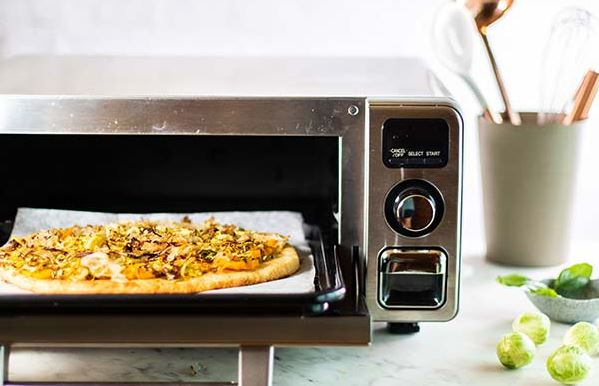 Pizza being prepared in a Sharp Supersteam Countertop Oven.