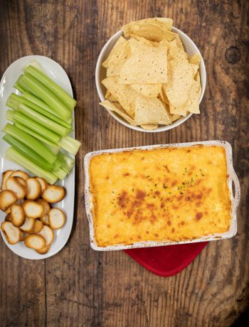 Buffalo chicken dip with chips and celery.