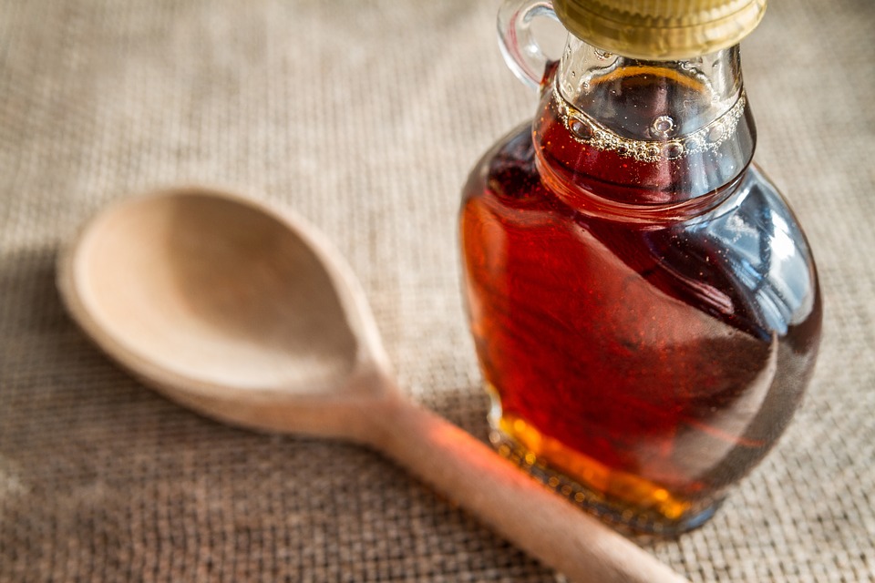 Homemade Pancake Syrup next to a wooden spoon.