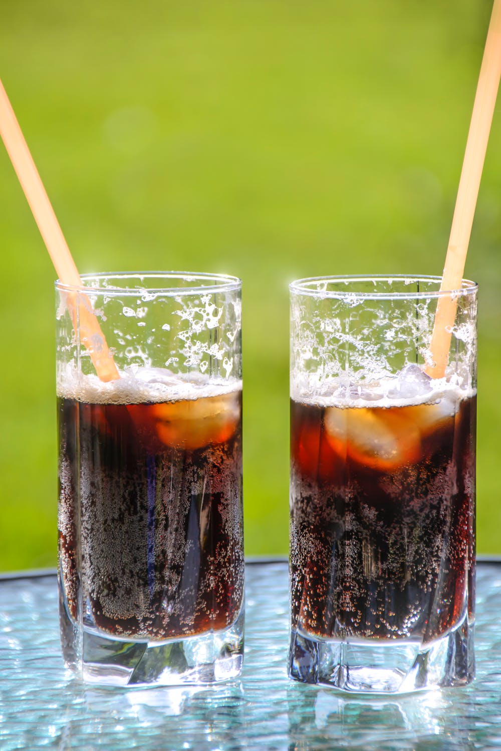 Homemade soda in two glasses outdoors.