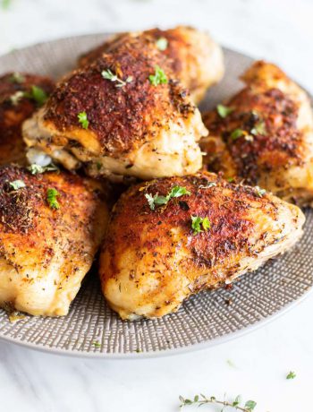 Oven Baked Chicken Thighs on a plate.