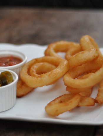 Old Fashioned Onion Rings on a plate with dips.